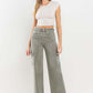 90s super high rise loose cargo jeans with ultra-high waist and cargo pockets styled with white crop top and heels