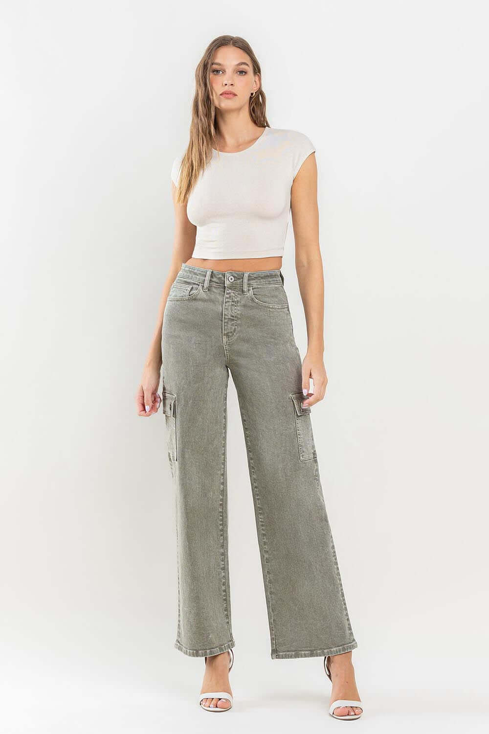 90s super high rise loose cargo jeans with ultra-high waist and cargo pockets styled with white crop top and heels