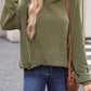 Woman wearing textured kangaroo pocket long sleeve hoodie in green, paired with blue jeans and a brown crossbody bag