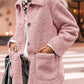 Woman wearing Bella Road Sherpa Pocketed Collared Neck Long Sleeve Jacket in pink, standing on a city street.