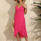 Woman wearing a pink backless tassel surplice spaghetti strap cover-up dress with a straw hat, standing outdoors.