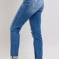 Judy Blue plus size button fly distressed jeans with pockets in a stylish side view, perfect for casual wear.