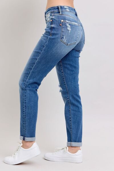 Judy Blue plus size button fly distressed jeans with pockets in a stylish side view, perfect for casual wear.