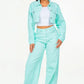 Model showcasing mint green high waist distressed wide leg jeans and matching jacket for a chic, trendy look.