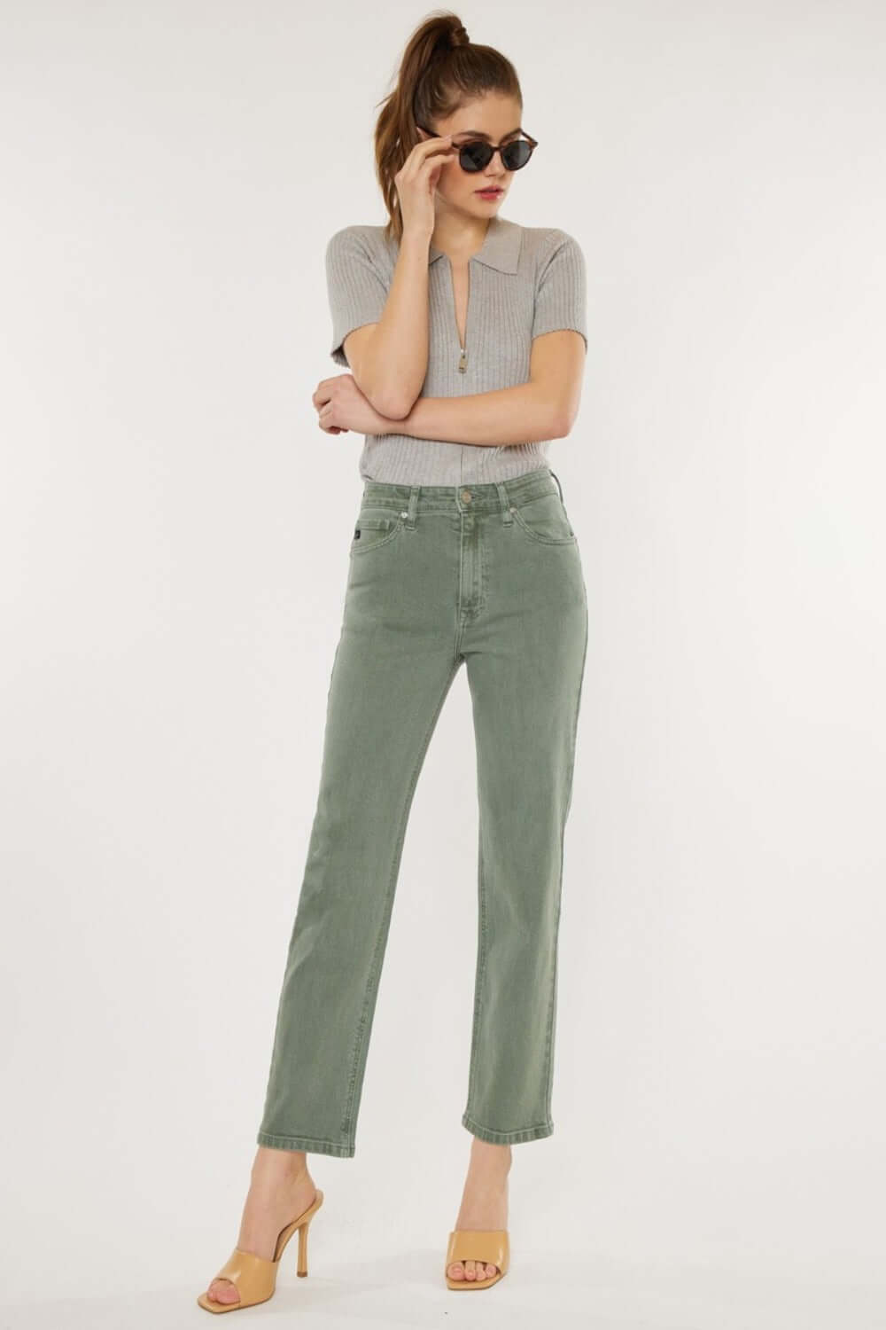 Woman modeling Kancan Ultra High Rise Straight Jeans in olive, paired with a grey top and sandals for a chic vintage-inspired look.