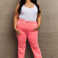 Woman wearing Kenya High Waist Side Twill Straight Jeans in pink, paired with a white tank top, exuding style and confidence