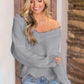 Woman wearing Bella Road Frayed Hem Dropped Shoulder Sweater in gray, exuding casual style and comfort.