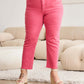 Woman wearing Crop Dylan Full Size Tummy Control High Waist Raw Hem Jeans in pink, showcasing stylish and comfortable high-waisted design RFM Jeans