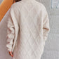 Woman wearing Bella Road Diamond Round Neck Long Sleeve Sweater from the back, showcasing diamond pattern and soft fabric.