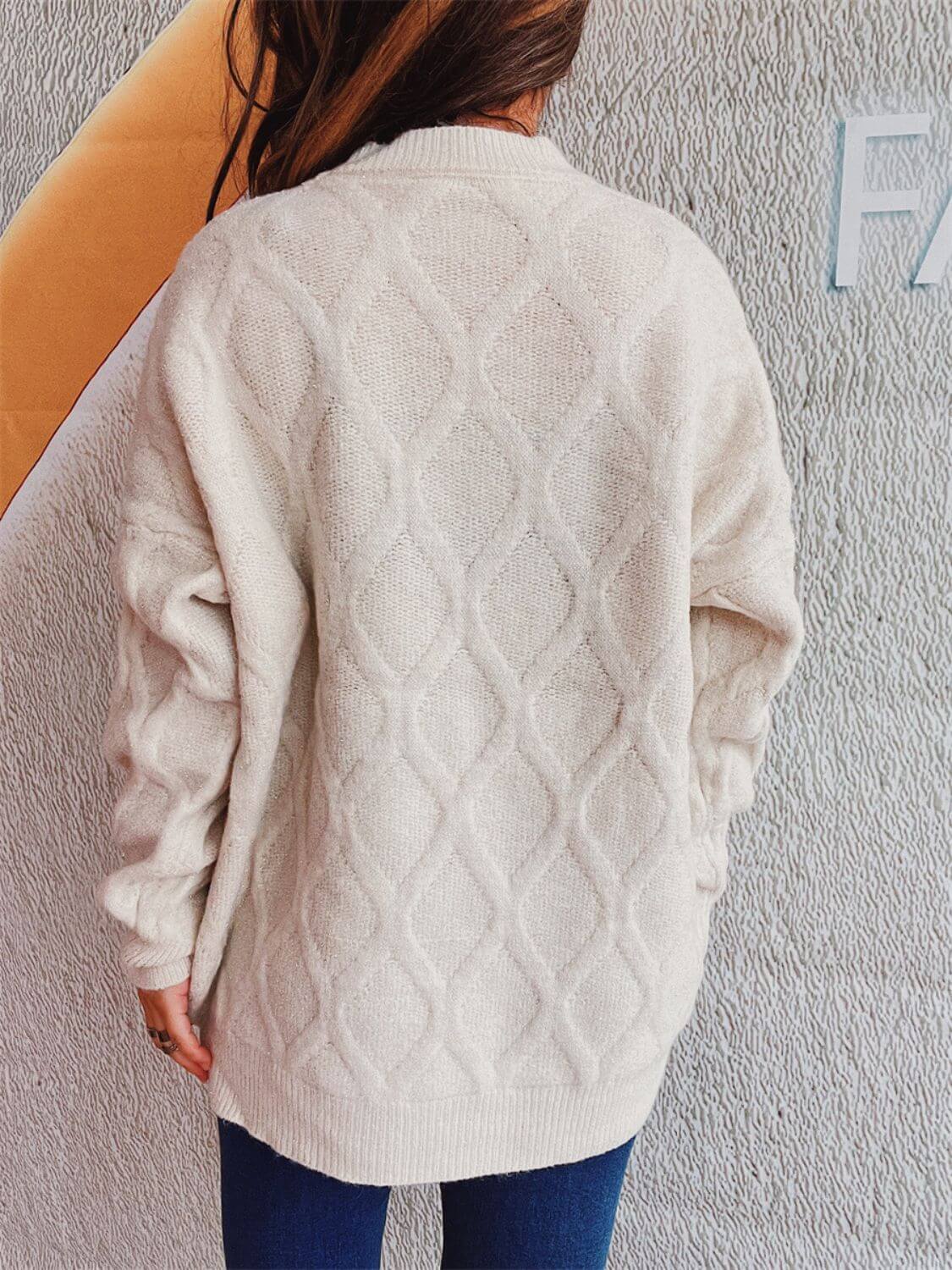 Woman wearing Bella Road Diamond Round Neck Long Sleeve Sweater from the back, showcasing diamond pattern and soft fabric.