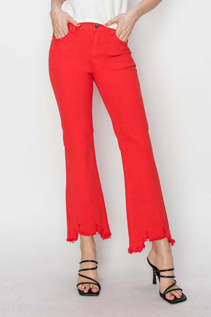 Woman wearing red raw hem bootcut jeans with pockets from Risen Jeans, showcasing modern denim style and edgy detailing.