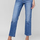 Model showcasing RISEN Full Size Tummy Control High Rise Crop Straight Jeans in light blue denim.