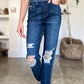 Woman wearing High Waist Rigid Magic Heavy Destroy Straight Judy Blue Jeans with heavy distressing and straight-leg design.