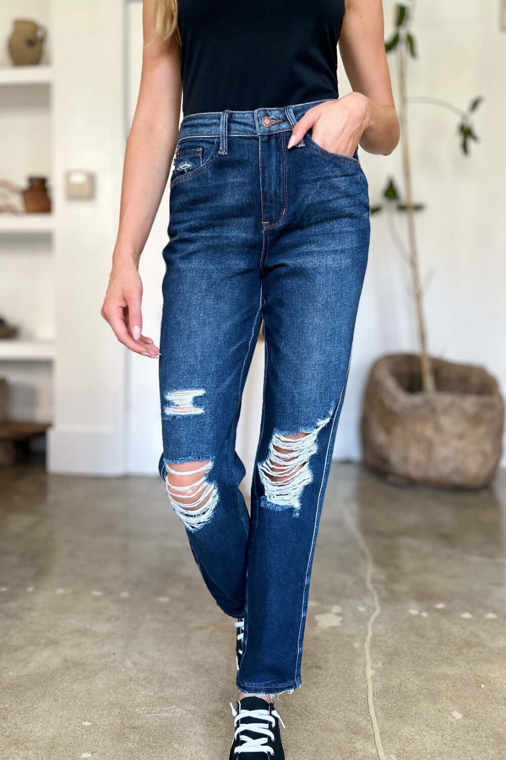 Woman wearing High Waist Rigid Magic Heavy Destroy Straight Judy Blue Jeans with heavy distressing and straight-leg design.