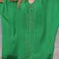 Woman wearing a green cutout V-neck three-quarter sleeve cover-up with openwork design on the beach.