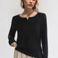 Woman wearing Basic Bae Notched Long Sleeve T-Shirt in black, showcasing a chic notched neckline and comfy fit.