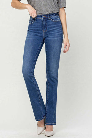 High Waist Bootcut Jeans in blue denim, featuring slimming high waist design and classic bootcut style, paired with a grey top and white heels