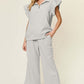 Woman wearing a Texture Ruffle Short Sleeve Top and Drawstring Wide Leg Pants Set in light gray with pockets, slightly stretchy fabric.