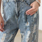 Trendy Washed Barrel Leg High Waist Distressed Jeans with edgy destroyed detailing and metal gold buttons for a chic fashion-forward look