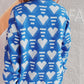 Woman wearing Bella Road Heart Contrast Long Sleeve Dropped Shoulder Sweater in blue with white heart pattern