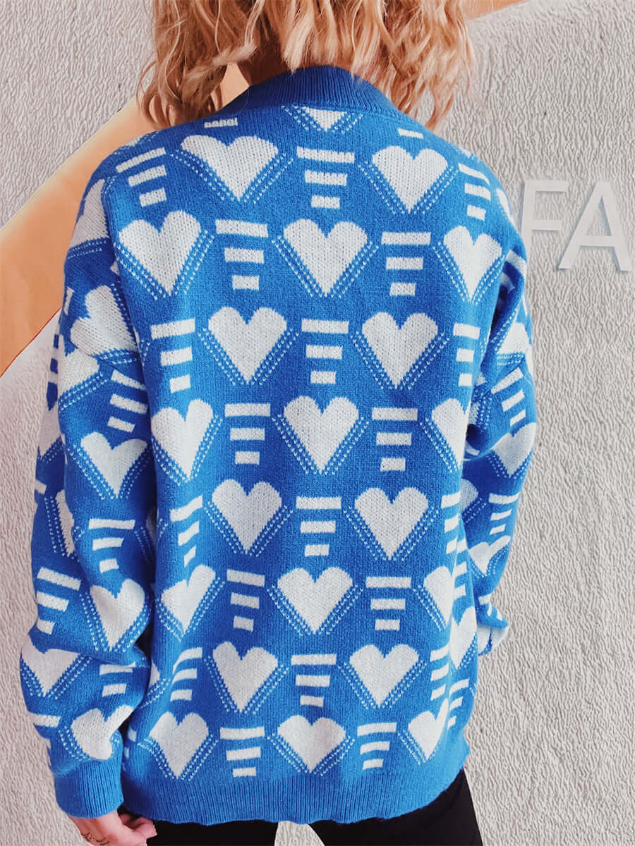 Woman wearing Bella Road Heart Contrast Long Sleeve Dropped Shoulder Sweater in blue with white heart pattern