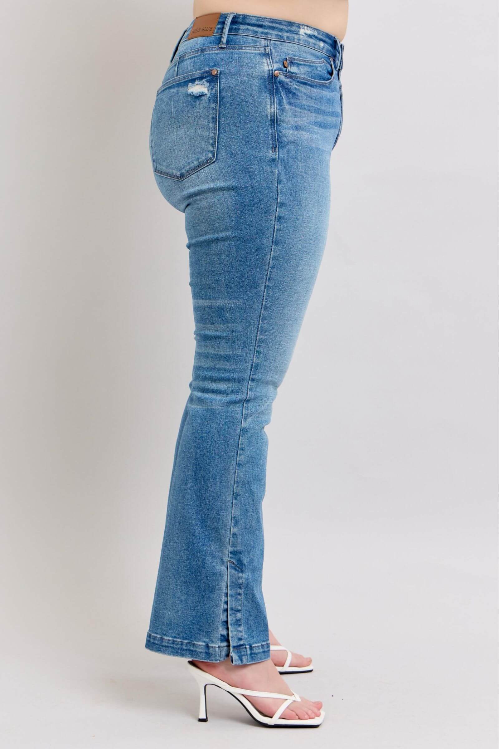 Side view of Judy Blue high waist tummy control vintage wash slim bootcut jeans with trendy side slit detail.