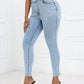 Woman modeling Bella Road High Waist Skinny Jeans with Pockets in light blue, paired with black top and high heels.