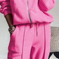 Bella Road zip up long sleeve top and pants set in vibrant pink, perfect for chic and confident style.