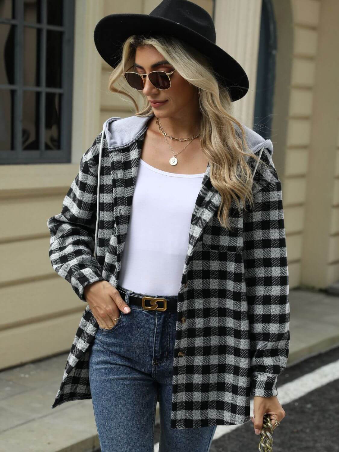 Woman wearing Bella Road Drawstring Plaid Long Sleeve Hooded Jacket with black hat and sunglasses