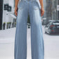 Woman wearing wide leg jeans with pockets, buttoned and slightly stretchy, standing on a city sidewalk, showcasing back view of jeans.