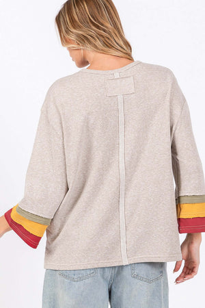 Woman wearing French Terry Color Block T-Shirt with 3/4 sleeves and multi-color detailing, seen from the back.