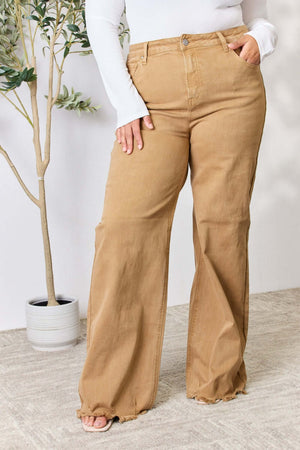 Woman wearing Risen Jeans Fringe Hem Wide Leg jeans with a high-waisted, pocketed design in a casual setting.