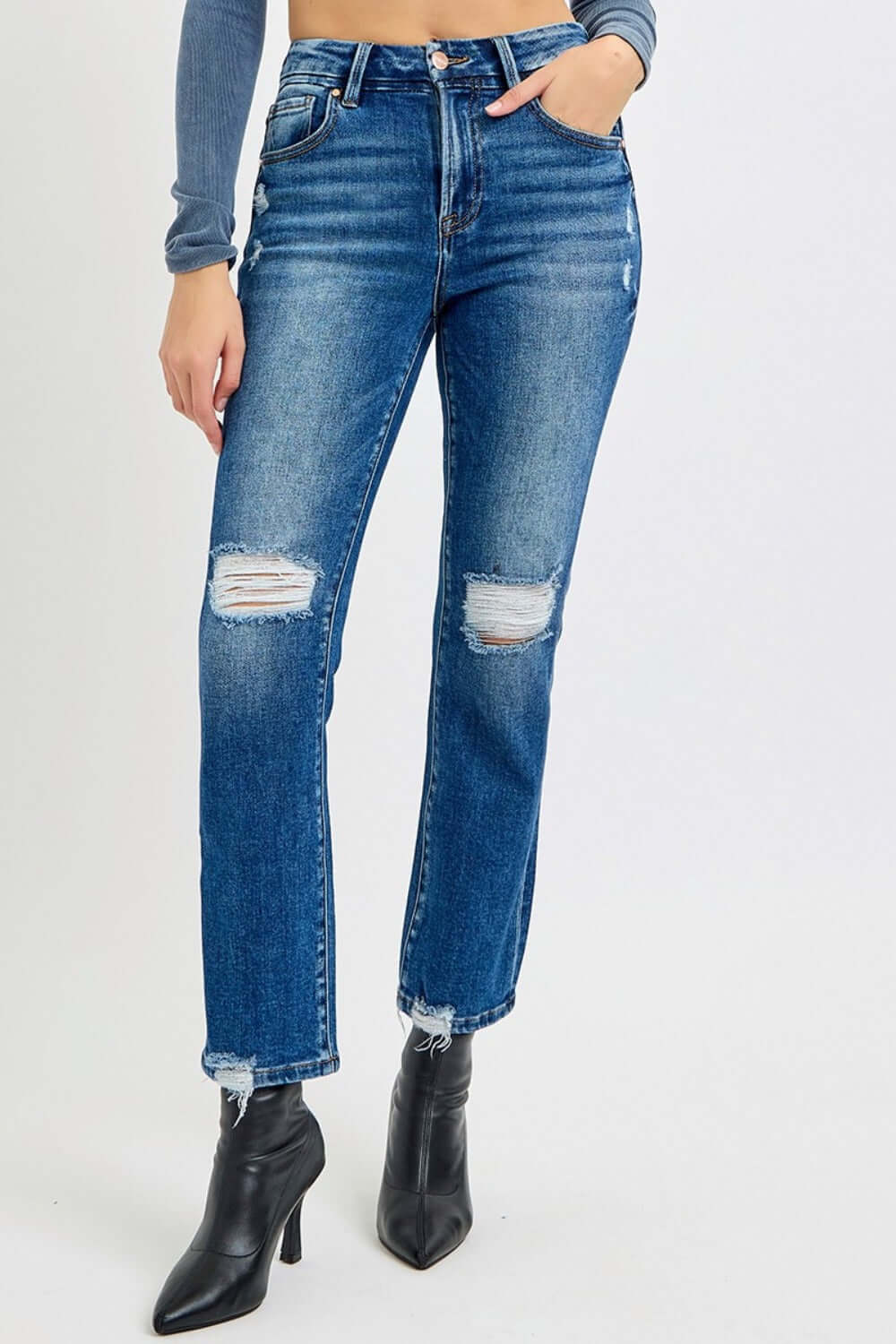 High Rise Distressed Crop Straight Jeans with edgy ripped knees and flattering fit, styled with black heeled boots for a chic look.