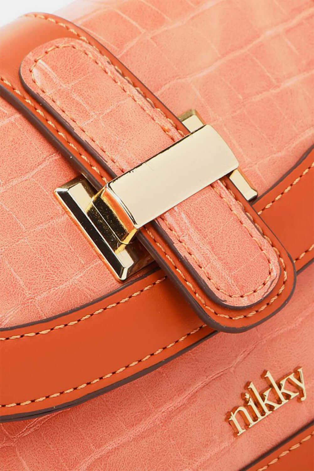 Close-up of Nicole Lee USA Croc Embossed Crossbody Bag with gold buckle and "Nikky" inscription, showcasing luxurious texture and design.