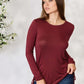 Woman wearing burgundy drawstring round neck long sleeve top