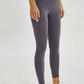 Stylish woman in gray Millennia wide seamless band waist sports leggings, perfect for workouts and adventures.