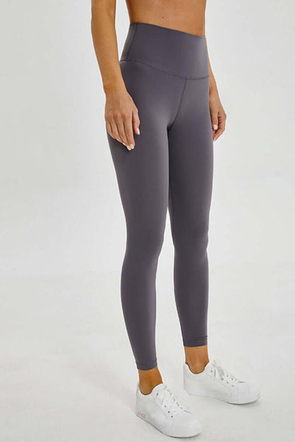 Stylish woman in gray Millennia wide seamless band waist sports leggings, perfect for workouts and adventures.