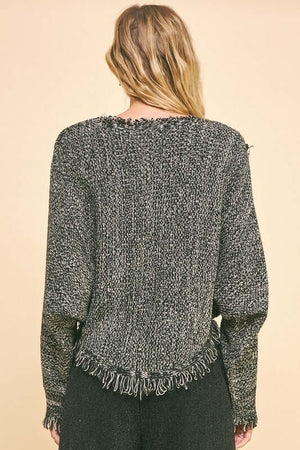 Back view of Davi & Dani fringe hem asymmetrical crop sweater, showcasing its stylish bohemian design and textured details.