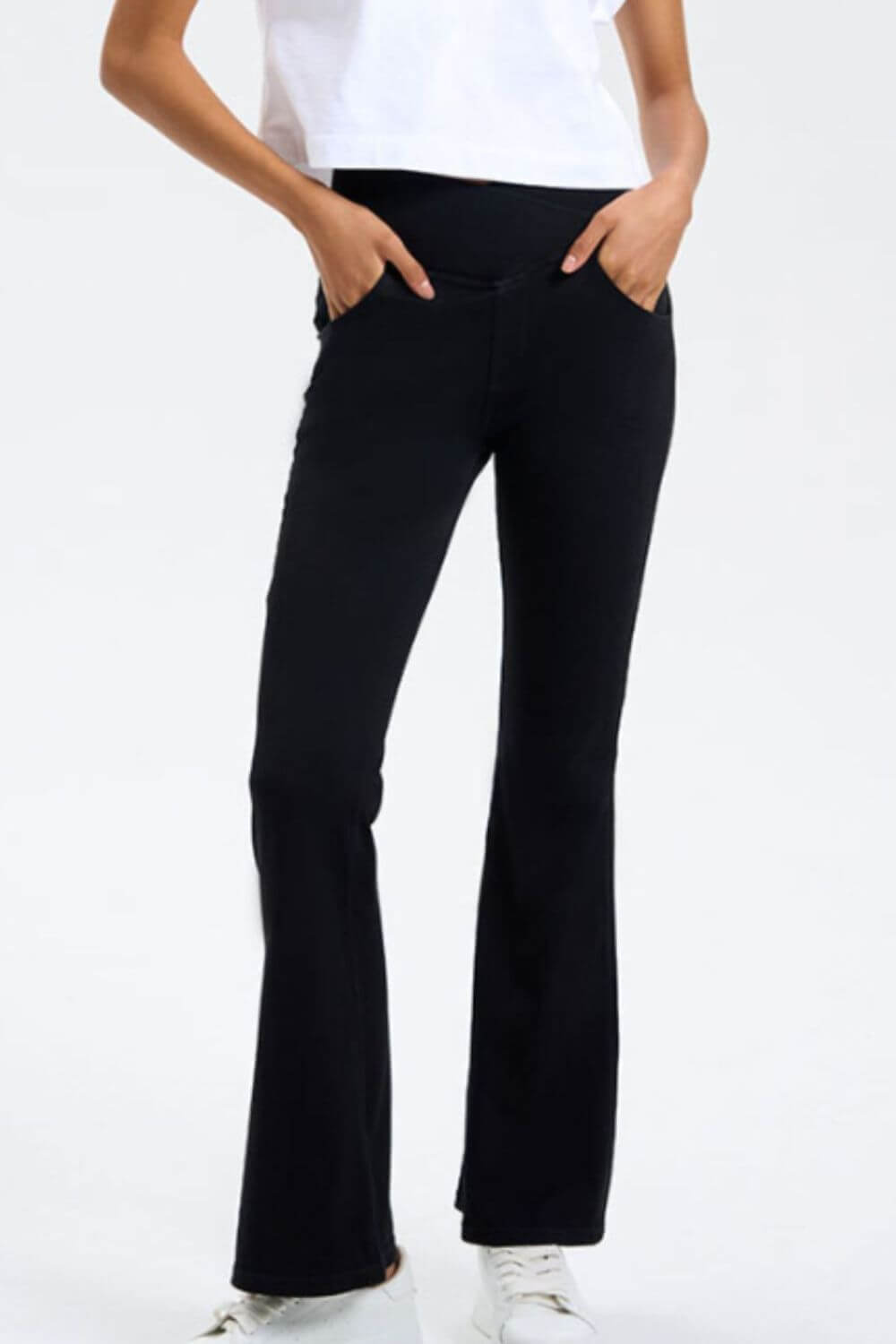 Model showcasing Basic Bae Pocketed Highly Stretchy Bootcut Jeans in black, highlighting comfort and style with pockets.