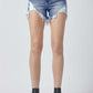 Risen Jeans raw hem asymmetrical waist denim shorts with casual cool style, modeled with black ankle boots.