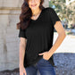 Woman wearing Basic Bae Bamboo V-Neck Short Sleeve T-Shirt in black, styled with blue jeans, standing outdoors.