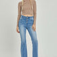 Stylish high rise button fly bootcut jeans with flattering silhouette and vintage touch, perfect for versatile wear.