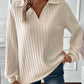 Woman wearing ribbed Johnny collar long sleeve T-shirt in cream, paired with jeans.