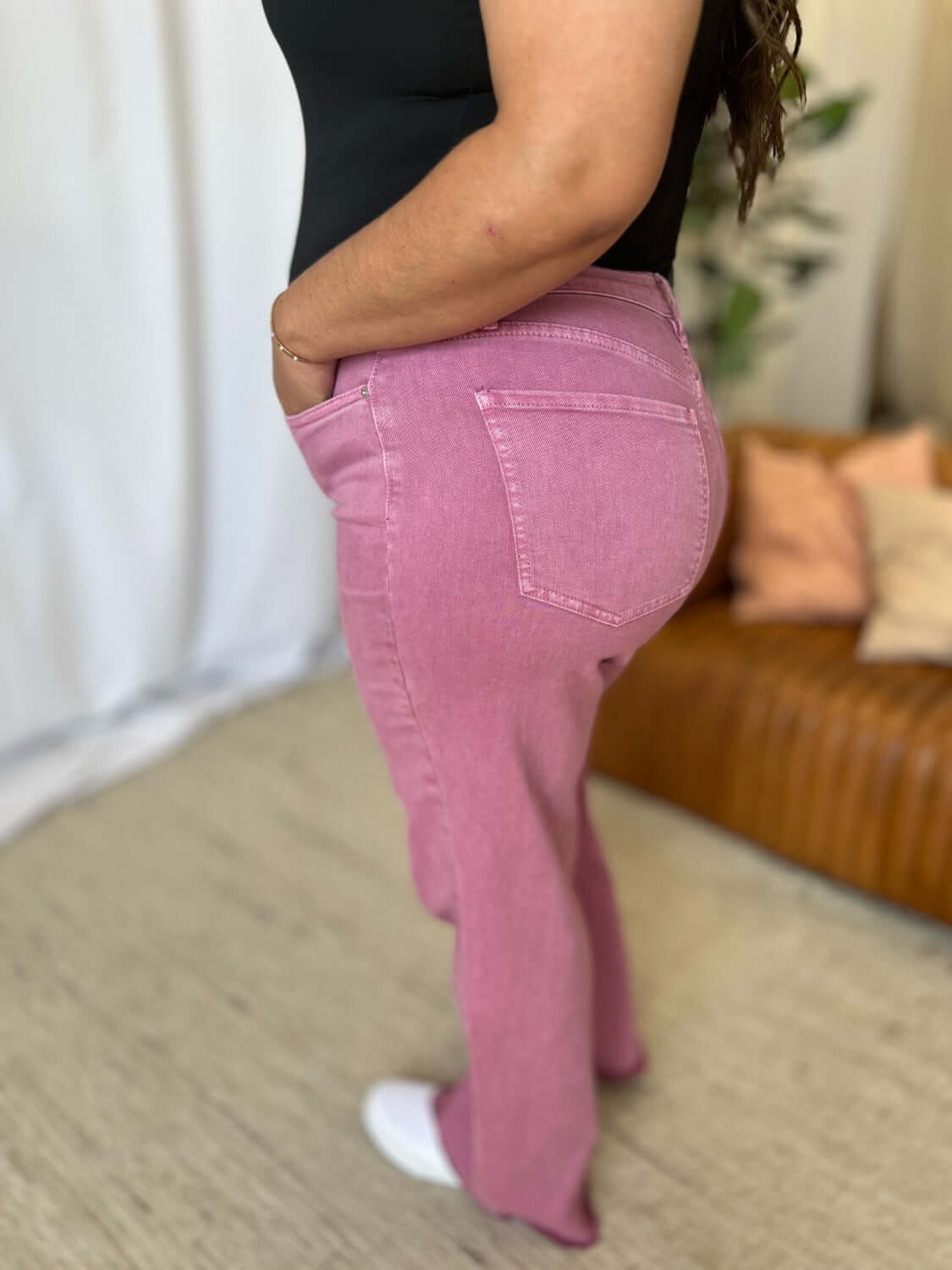 Model wearing RFM Full Size High Rise Garment Dye Wide Leg Jeans in pink, showcasing relaxed fit and stylish high-waist design.