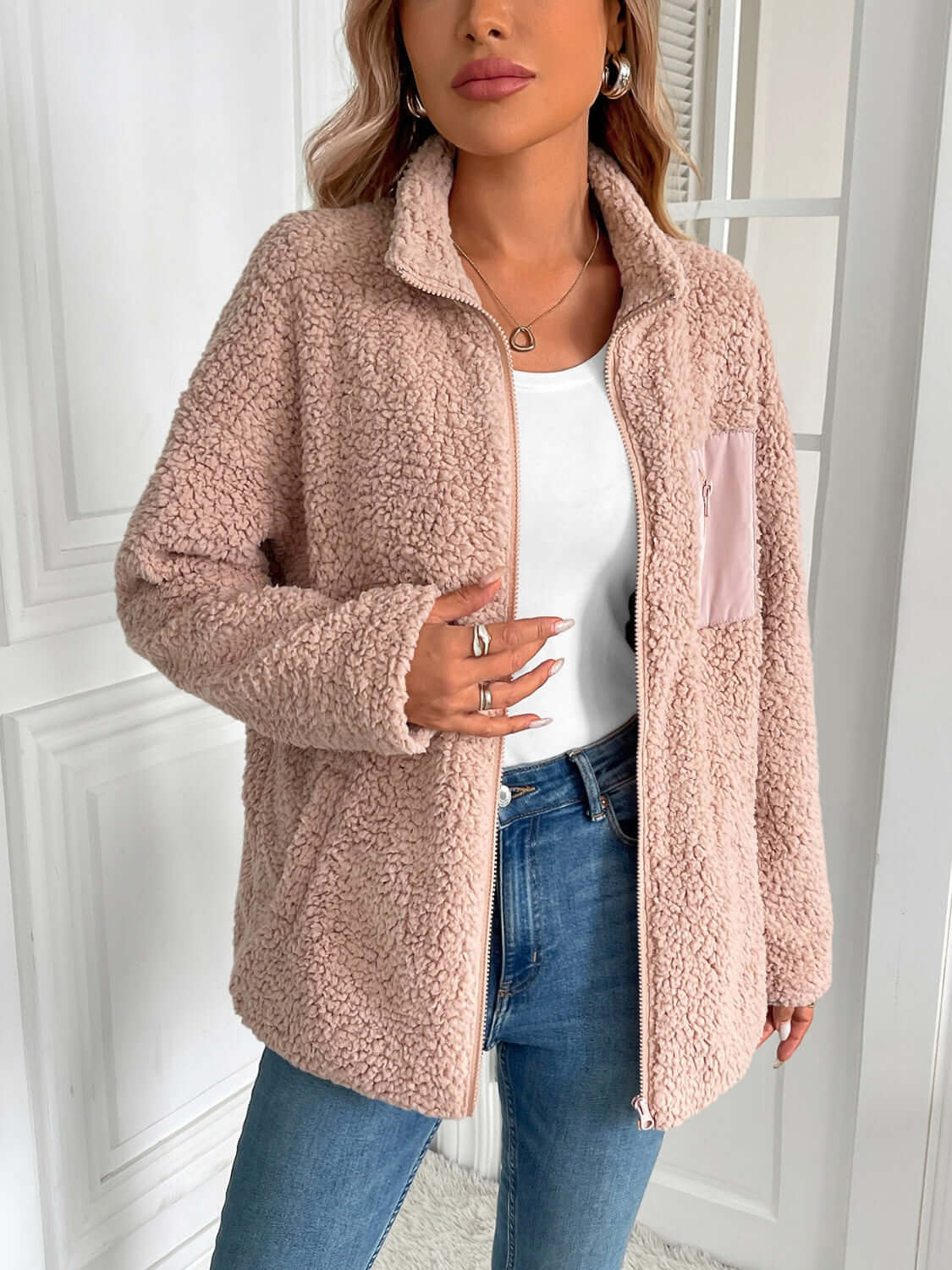 Cozy Ivy Lane Fuzzy Jacket in soft pink worn by model; features zip up, long sleeves, and pocket; perfect for chilly days.