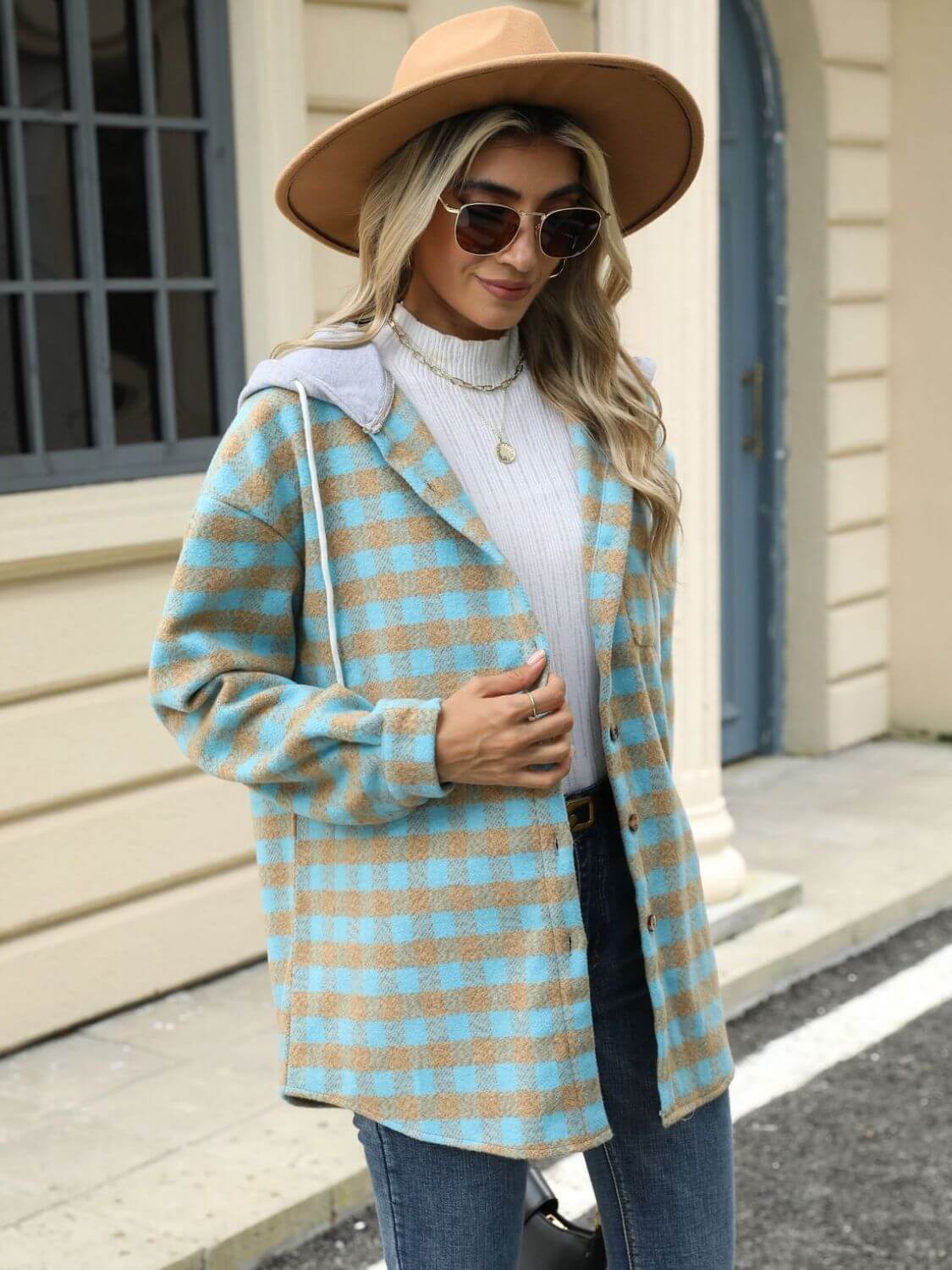 Woman wearing Bella Road Drawstring Plaid Long Sleeve Hooded Jacket paired with jeans, hat, and sunglasses.