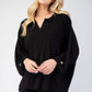 Celeste full size notched three-quarter sleeve blouse in black, featuring a chic neckline and stylish fit for versatile looks.