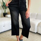 Petite High Waist Button Fly Judy Blue Jeans in black, with a stylish vintage-inspired design modeled in a contemporary living room setting.