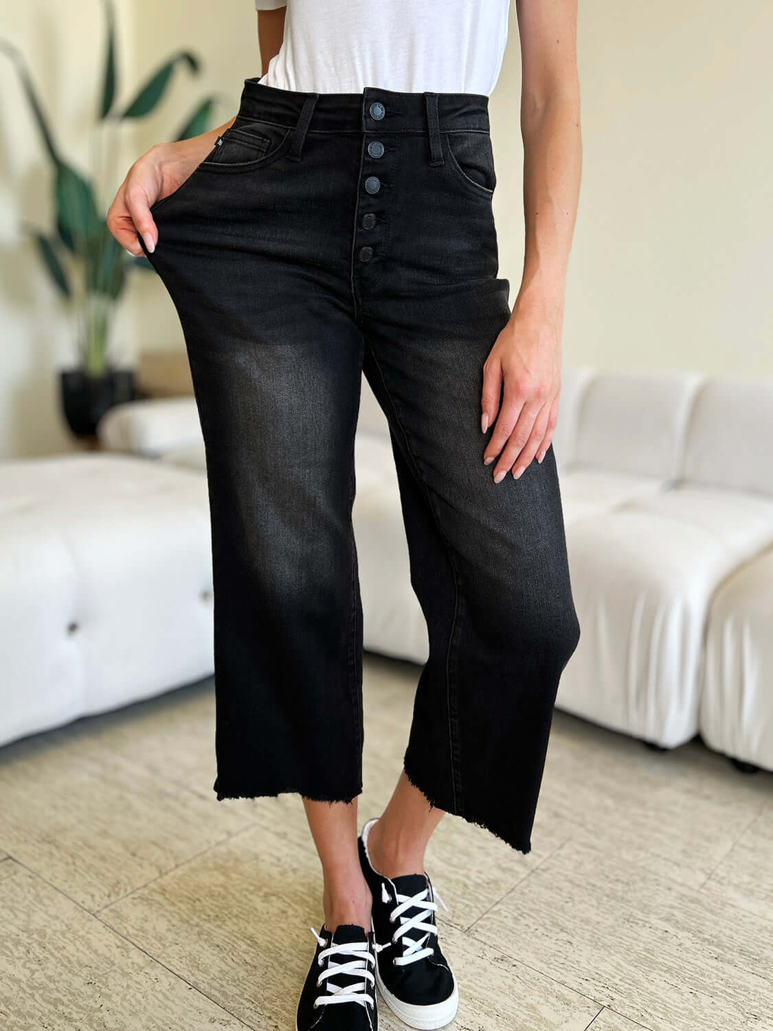 Petite High Waist Button Fly Judy Blue Jeans in black, with a stylish vintage-inspired design modeled in a contemporary living room setting.