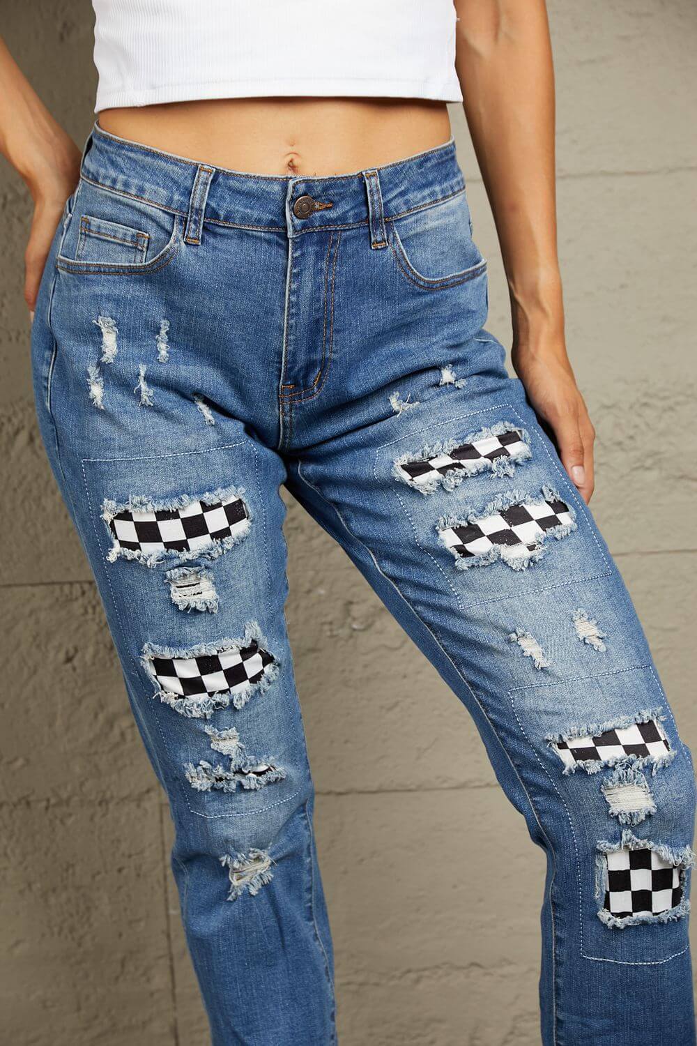 Baeful Checkered Patchwork Mid Waist Distressed Jeans in flat lay style showing patchwork and distressed details.